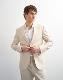 Model wearing Linen rich blazer in stone