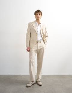 Model wearing Linen rich blazer in stone