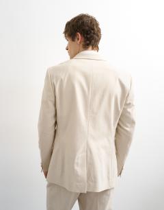Model wearing Linen rich blazer in stone