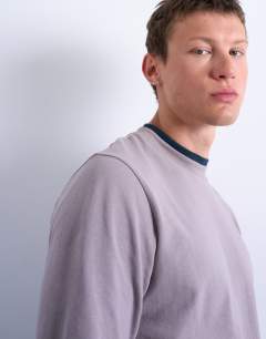 Model wearing Long sleeve doubled layered tee in lilac and navy