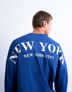 Model wearing Long sleeve oversized New York City print t-shirt in mid blue