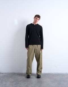 Model wearing Long sleeve relaxed fit waffle t-shirt with henley in black