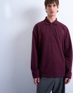 Model wearing Long sleeve textured polo in burgundy