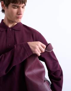 Model wearing Long sleeve textured polo in burgundy