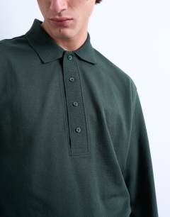 Model wearing Long sleeve textured polo in dark green