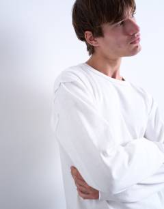 Model wearing Long sleeved heavy weight slub raw edge tee in white