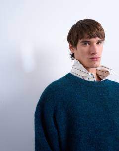 Model wearing Loose knit crew jumper in dark blue
