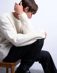 Model wearing Loose knit crew jumper in ecru