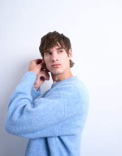 Model wearing Loose knit crew jumper in mid blue