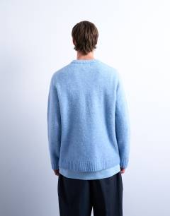 Model wearing Loose knit crew jumper in mid blue
