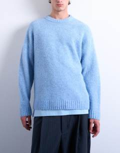 Model wearing Loose knit crew jumper in mid blue