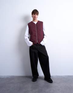 Model wearing Onion quilted gilet in burgundy