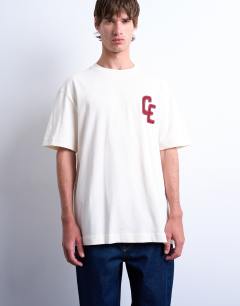 Model wearing Oversized Chateau Ermont applique t-shirt with back print in ecru
