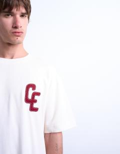 Model wearing Oversized Chateau Ermont applique t-shirt with back print in ecru