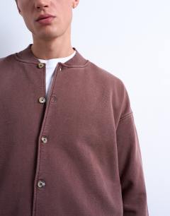 Model wearing Oversized fit bomber in washed brown