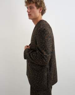 Model wearing Oversized fit collarless double breasted blazer with leopard print in brown