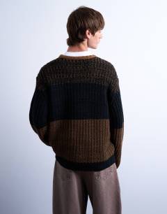 Model wearing Oversized fit colour block stripe jumper in brown