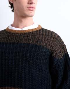Model wearing Oversized fit colour block stripe jumper in brown