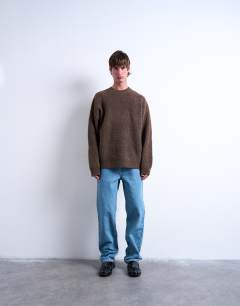 Model wearing Oversized fit crew jumper in brown