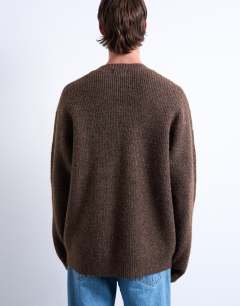 Model wearing Oversized fit crew jumper in brown