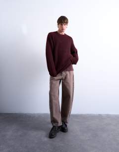 Model wearing Oversized fit crew jumper in burgundy