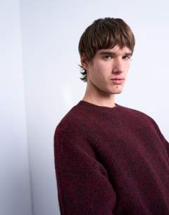 Model wearing Oversized fit crew jumper in burgundy