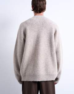 Model wearing Oversized fit crew jumper in stone