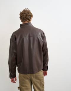 Model wearing Oversized fit faux leather 1/4 zip funnel neck jacket in brown