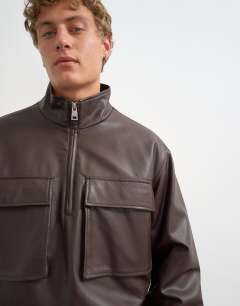 Model wearing Oversized fit faux leather 1/4 zip funnel neck jacket in brown