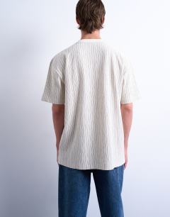 Model wearing Oversized fit fine stripe t-shirt in ecru