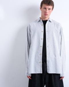Model wearing Oversized fit flannel check shirt in light blue