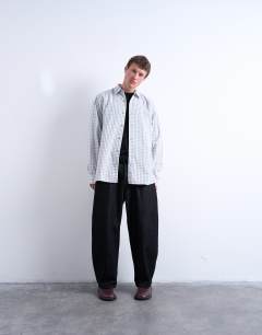 Model wearing Oversized fit flannel check shirt in light blue