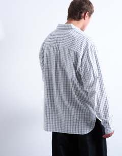 Model wearing Oversized fit flannel check shirt in light blue