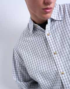 Model wearing Oversized fit flannel check shirt in light blue
