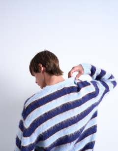 Model wearing Oversized fit fluffy knitted stripe cardigan in blue