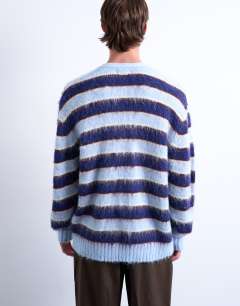 Model wearing Oversized fit fluffy knitted stripe cardigan in blue
