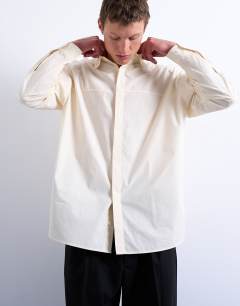 Model wearing Oversized fit formal shirt in light yellow