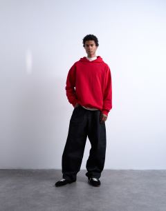 Model wearing Oversized fit heavyweight loopback hoodie in red