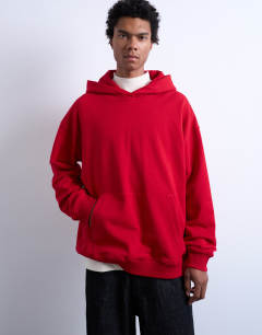 Model wearing Oversized fit heavyweight loopback hoodie in red
