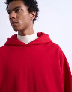 Model wearing Oversized fit heavyweight loopback hoodie in red