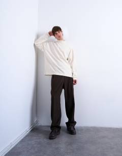 Model wearing Oversized fit high neck long sleeve t-shirt in ecru
