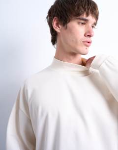 Model wearing Oversized fit high neck long sleeve t-shirt in ecru