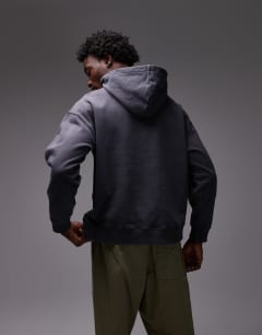 Model wearing Oversized fit hoodie in washed black