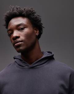 Model wearing Oversized fit hoodie in washed black