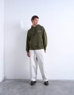 Model wearing Oversized fit hoodie with sorrow embroidery in khaki