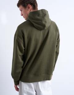 Model wearing Oversized fit hoodie with sorrow embroidery in khaki