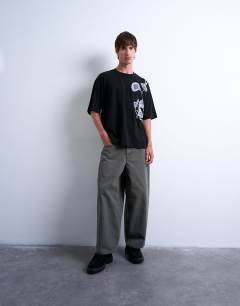 Model wearing Oversized fit interlock t-shirt with floral embroidery in black