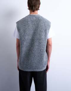 Model wearing Oversized fit knitted button through tank in charcoal