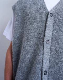 Model wearing Oversized fit knitted button through tank in charcoal