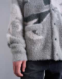 Model wearing Oversized fit knitted cardigan with camo design in grey